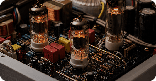 Glowing vacuum tubes on an audio amplifier circuit board